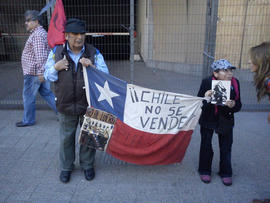 Personas sosteniendo bandera chilena con mensaje "¡¡CHILE NO SE VENDE!!"