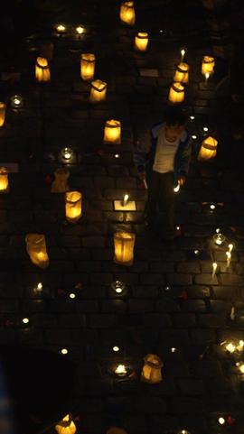 Velas y claveles rojos sobre adoquines conmemorativos en Londres 38