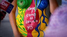 Mujer con cuerpo pintado con consigna "Cuando y como lo decido yo"